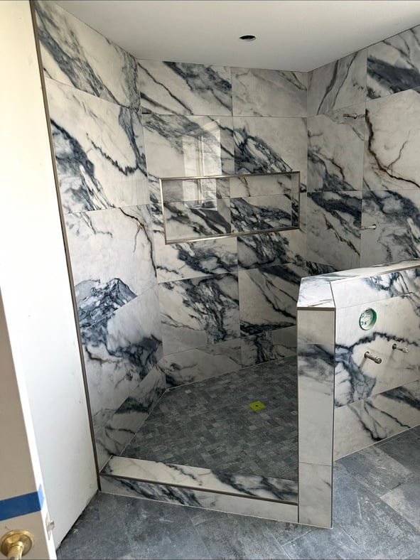 Blue-Vein Marble-Look Shower With a Knee Wall
