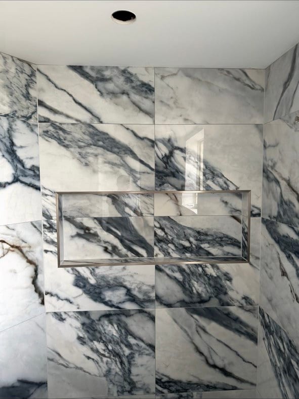 Blue-Vein Marble-Look Shower With a Knee Wall
