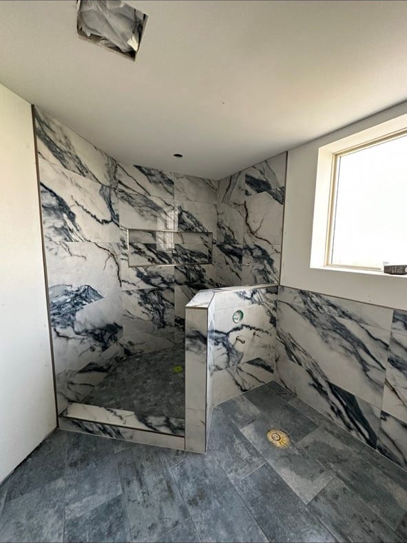 Blue-Vein Marble-Look Shower With a Knee Wall