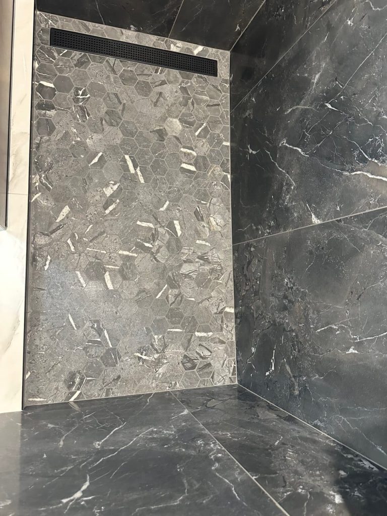 Charcoal Marble-Look Shower in a White Marble-Look Bathroom