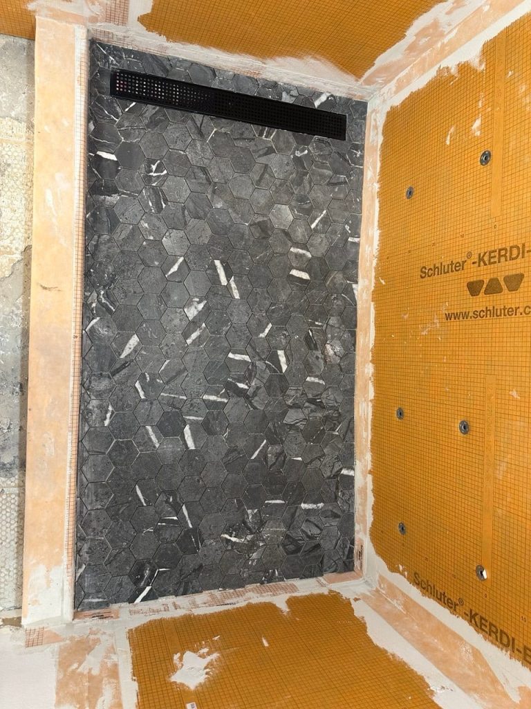 Charcoal Marble-Look Shower in a White Marble-Look Bathroom