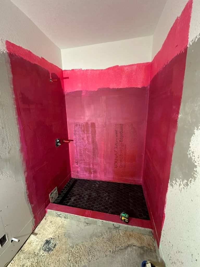 Black Glossy Subway Shower With a Fan-Pattern Wall