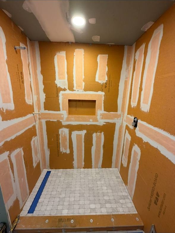 Walk-In Shower With a Fluted Accent Wall