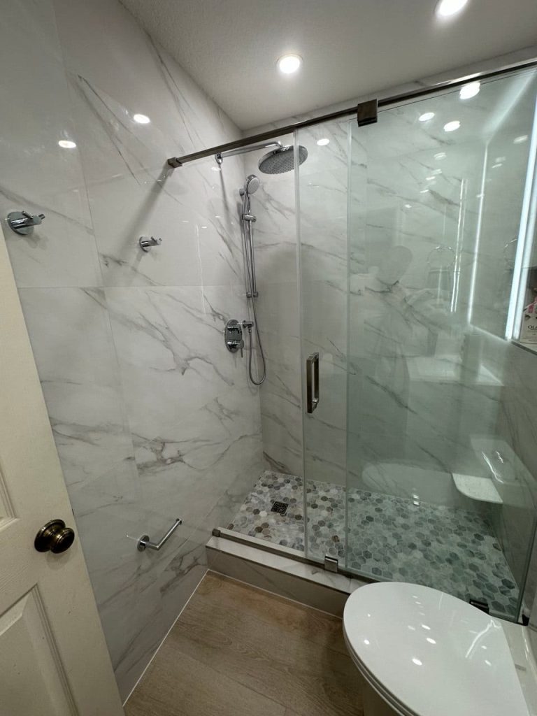 Marble-Look Shower With a Hexagon Mosaic Floor