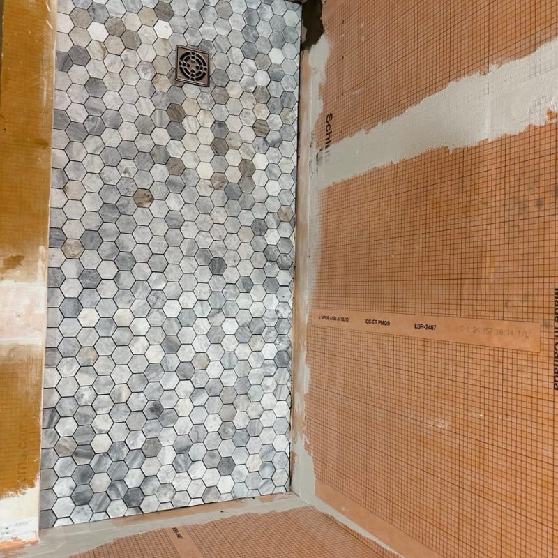 Marble-Look Shower With a Hexagon Mosaic Floor