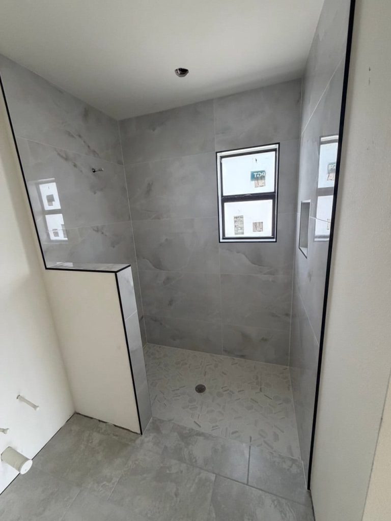 Shower With a Window and Hexagon Mosaic Floor